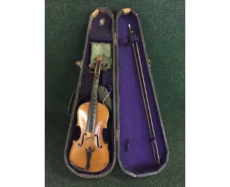 A violin and bow in coffin case bearing the label Stradivarius 