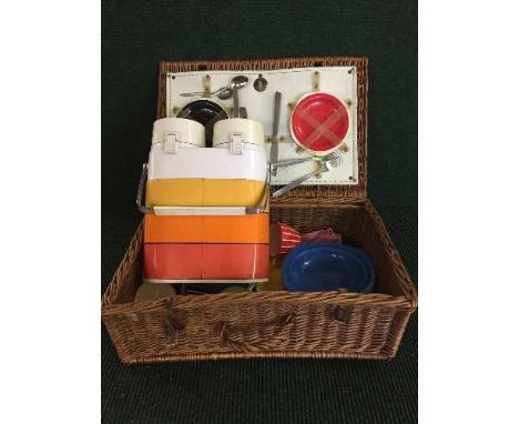 A mid twentieth century folding deck chair together with a wicker picnic basket and contents, a picnic flask 