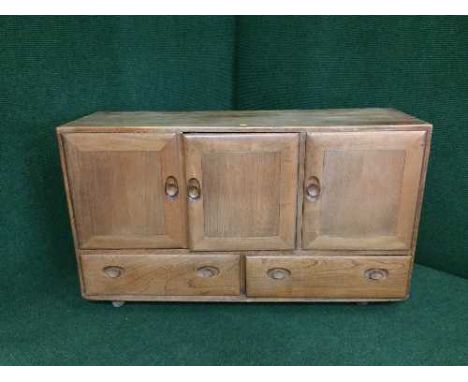 An Ercol triple door sideboard 