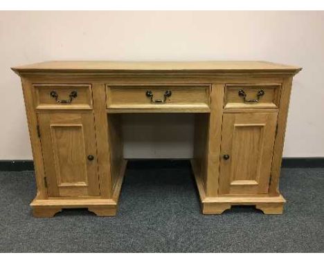 A contemporary light oak pedestal desk