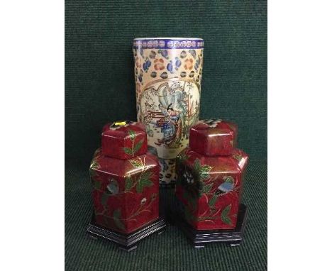 Two Oriental ceramic temple jars on wooden bases together with a stick stand