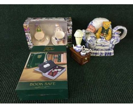 A tray of boxed Ringtons tea time teapot (damaged) with certificate, a Ringtons book safe and a pair of boxed Ringtons cerami