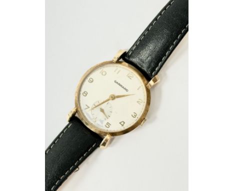 9ct gold. Presented by Lord Thomson of Fleet. A 1960’s 9ct gold Garrard watch. To Mr E. H. Davies after 40 years service with