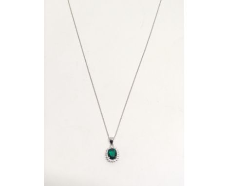 A silver &amp; emerald cz pendant on a silver chain