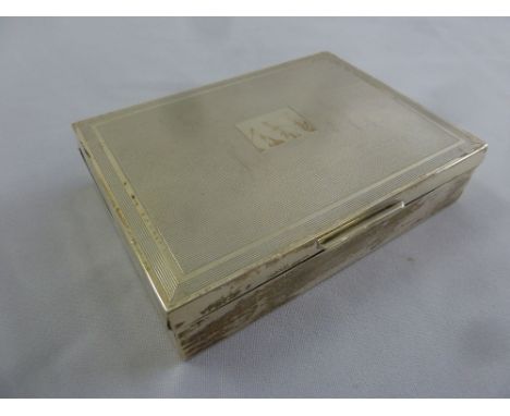 A rectangular silver engine turned cigarette box with cedarwood lining