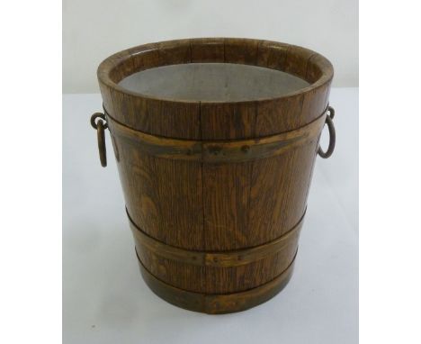 An Edwardian oak planter with brass mounts and side handles