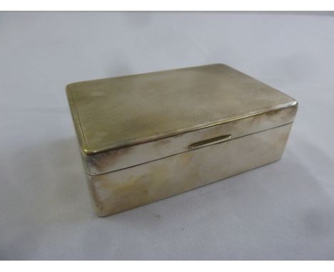 A rectangular silver engine turned cigarette box with cedarwood lining