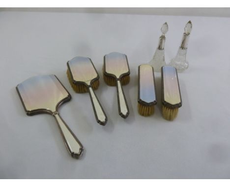 A five piece silver and enamel dressing table set and two dressing table bottles with silver collars