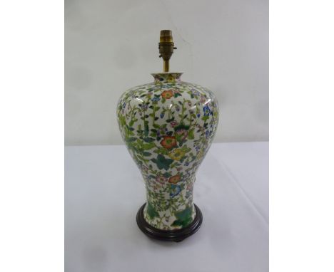 An Oriental famile verte baluster form table lamp