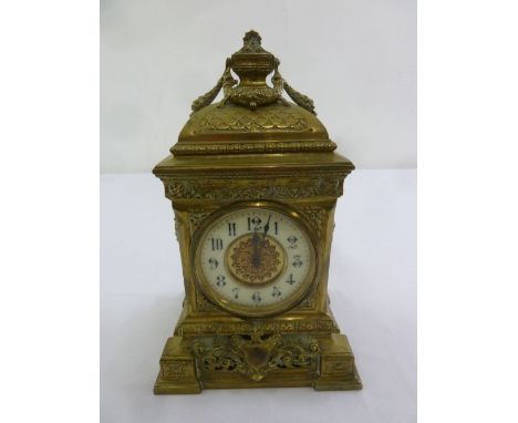 A French brass mantle clock, rectangular, enamel chapter ring, Arabic numerals surmounted by urn finial