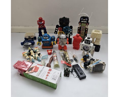 This is a vintage lot of various toy robots including figures heroes, an alarm clock and space missiles.&nbsp;