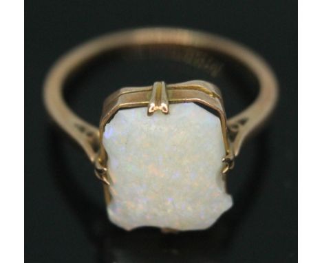 A ring set with a rectangular opal cabochon, band indistinctly marked '9ct', gross wt. 2.09g, size N.  