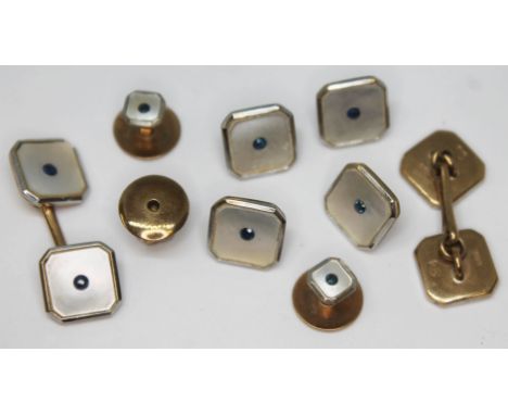 An Art Deco 9ct gold buttong and cufflink set, each set with mother of pearl and a central sapphire, Deakin &amp; Francis, gr