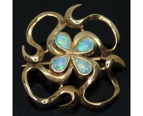 A modern Arts &amp; Crafts style hallmarked 9ct gold brooch set with four pear shaped precious opal cabochons, Cropp &amp; Fa