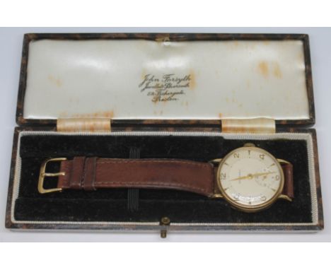 A 1950s hallmarked 9ct gold Garrard wristwatch with champagne signed dial, alternate hour markers and Arabic numerals and alp