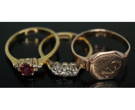 A group of three rings comprising a hallmarked 18ct gold diamond and glass filled ruby cluster, a three stone diamond ring ma