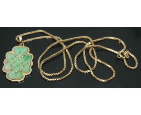 A jadeite jade pendant carved in a Celtic style cross, yellow metal mounted, pendant unmarked, on chain marked '9k', pendant 