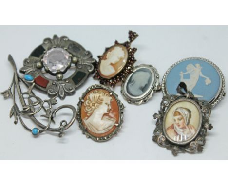 A mixed lot of brooches including a Victorian Scottish type white metal brooch set with an amethyst, a continental brooch wit