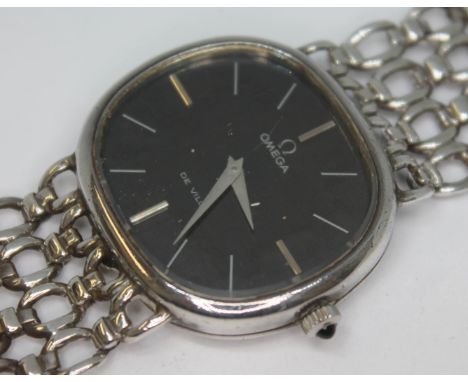 A 1974 silver Omega De Ville dress watch 8390 having signed black dial, silver hour batons and dauphine hands, snap back 31 x