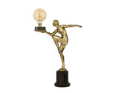 An Art Deco Silvered Spelter Figural Table Lamp, modelled as a semi-nude dancer, standing on one leg, with arms outstretched,