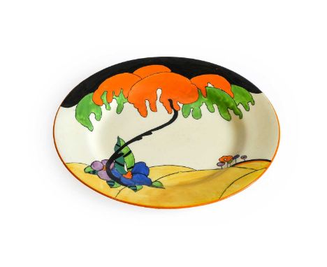 Clarice Cliff (1899-1972): A Bizarre Woodland Plate, painted with a tree and flowers, beneath a black sky and orange band, pr