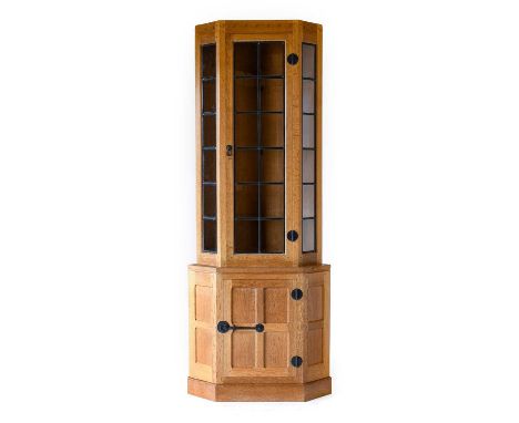 Workshop of Robert Mouseman Thompson (Kilburn): An English Oak Corner Display Cupboard, the upper section with leaded glazed 