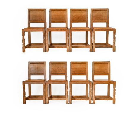 Workshop of Robert Mouseman Thompson (Kilburn): A Set of Eight English Oak Panel Back Dining Chairs, tan cow hide upholstered