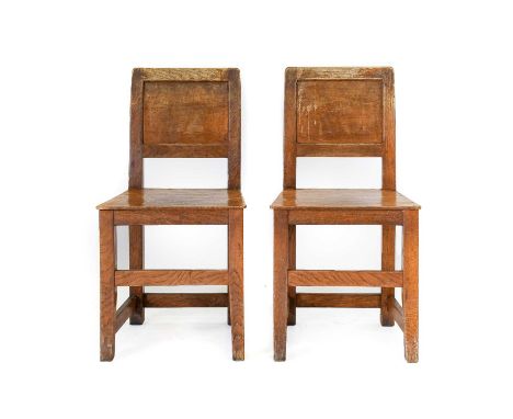 Workshop of Robert Mouseman Thompson (Kilburn): A Pair of English Oak Panel Back Chairs, solid seats, on square section legs,