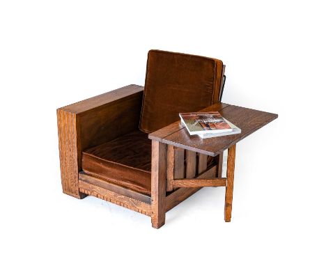A Heal's Oak Reclining Bookshelf Chair, circa 1933, with fold out table to one side, fitted book shelves to other, unmarked, 
