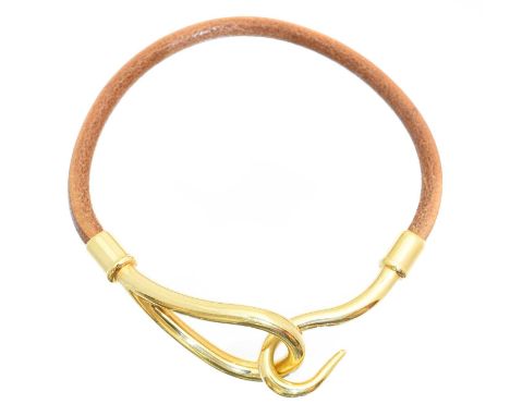 A Hermès Jumbo bracelet, the brown swift calfskin strap with gold-tone hook fastening, signed Hermès.18cmCondition report: Ov