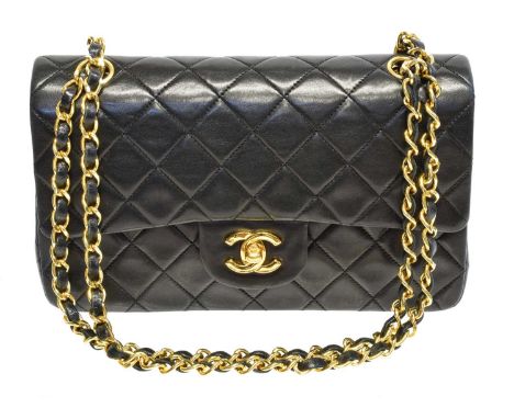 A Chanel Classic Double Flap Bag, circa 1989-91, the black quilted leather exterior with gold-tone hardware and chain handles