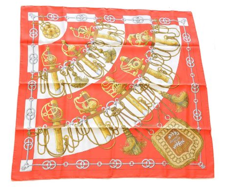 A Hermès "Cliquetis" silk scarf by Julia Abadie, circa 1972, the red, white, grey and gold pattern depicting swords and saber
