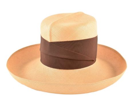 A Philip Treacy straw hat, with brown ribbon banding and curved rim.Approx 55cm.Condition report: Overall condition good to f