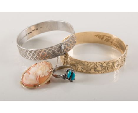 A collection of jewellery, two gold plated bangles, a silver solid half hinged bangle, a small mourning brooch with hair comp