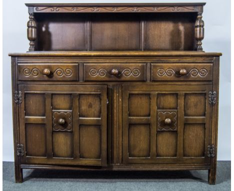  Reproduction oak court cupboard, shelf over, fitted with three frieze drawers, over two panelled doors, width 140cm.