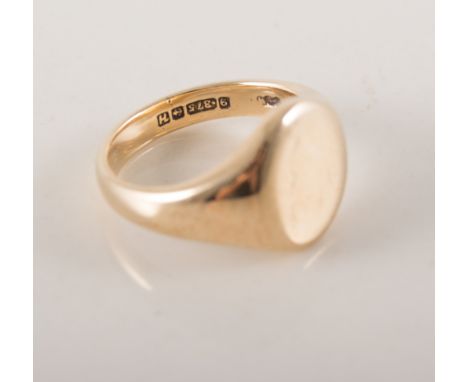 A 9 carat yellow gold signet ring, plain polished oval head, hallmarked Birmingham 1957, approximate weight 9.5gms. ring size