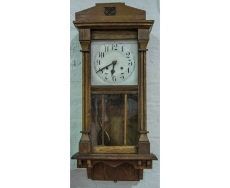 Edwardian oak wall clock, silvered dial, striking on a gong, 78cm.