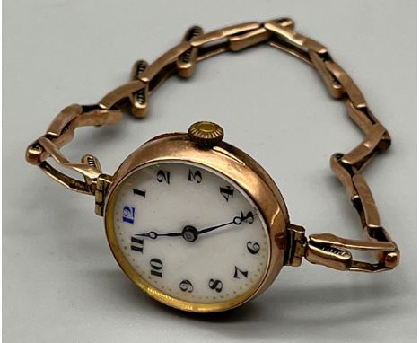 Ladies 9ct gold wrist watch, white enamel face, 9ct gold elasticated band. [18.14grams] 