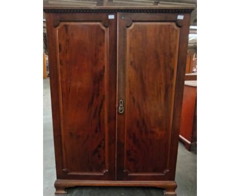 19th century double robe, the rectangular top with moulded cornice, above two panel doors leading to five interior shelves an