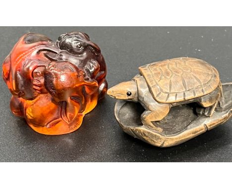 A Japanese hand carved amber netsuke of a rabbit family, signed by the artist. Together with a carved netsuke turtle- signed.