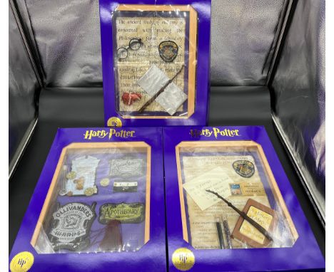 Three 'The Magic Cauldron Company' Limited Edition wall hanging Harry Potter display cabinets containing reproduction 'Wizard