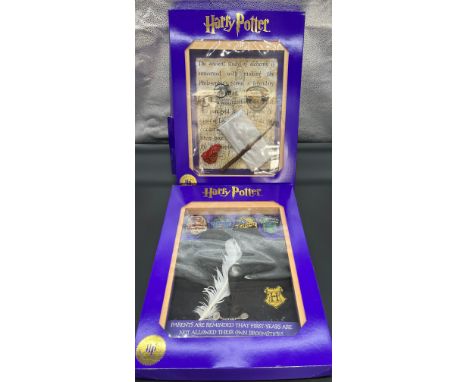 Two 'The Magic Cauldron Company' Limited Edition wall hanging Harry Potter display cabinets containing reproduction 'Wizardin