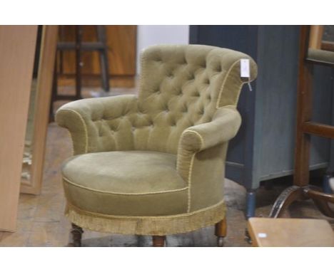 A Victorian walnut framed button back tub chair with upholstered back, arms and seat, in green velvet, with fringed tassel tr