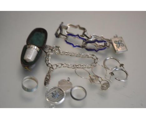 A silver thimble with original case, a white metal blue enamelled bracelet, a silver charm bracelet with boat charm, two vari