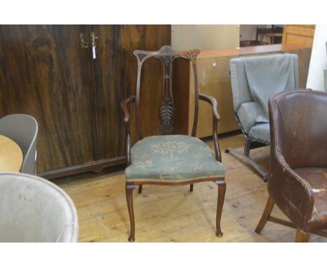 An Edwardian mahogany open armchair with pierced carved splat back, with stuffover seat in woven tapestry, on carved moulded 