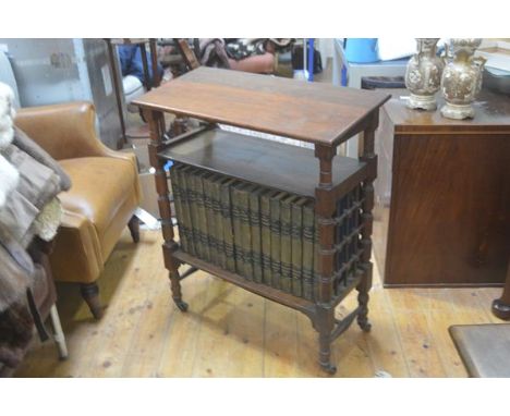 An oak Arts &amp; Crafts reading stand, the rectangular top with moulded edge above an open shelf, with lower shelf containin