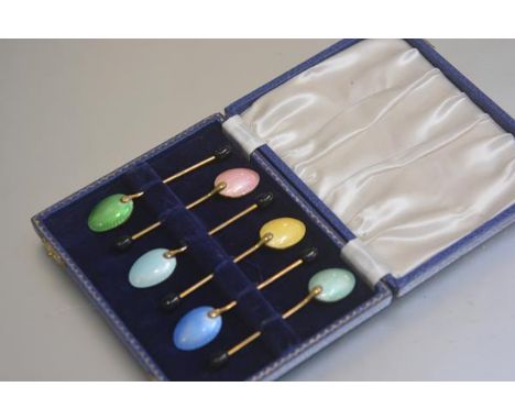 A set of six gilt metal guilloche enamelled bean handled coffee spoons in original fitted case (enamel in good condition)