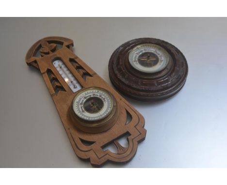 A treen carved ash aneroid wall barometer complete with thermometer in Art Nouveau style pierced carved frame (l.42cm x 17cm 