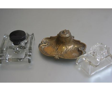 A French style brass desk inkstand with hinged top enclosing an original ceramic liner, with olive branch and ribbon decorati