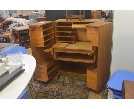 A 1950s/60s compactum home office, the twin opening panel doors enclosing a filing and shelf lined interior, with slide out d